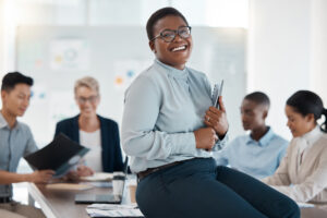 A smiling woman holding a professional growth plan