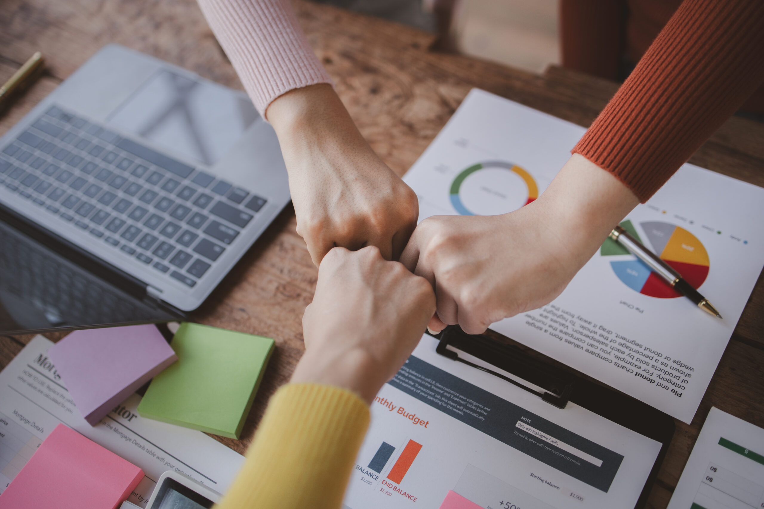 Sales and marketing experts fistbumping together